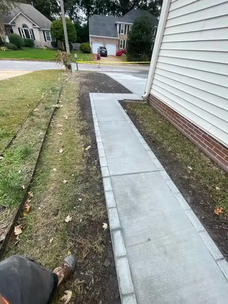 Concrete walkway along the side of a home